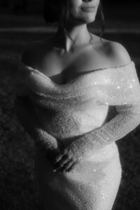 Artsy close-up of wedding dress textures and lace captured in warm golden hour light for a poetic film look.