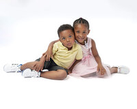 Two children seated together in studio portrait session in New Bern NC