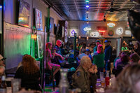 A small bar with two people playing music