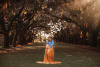Maternity Photos in Charleston, SC -- Expectant mother poses for Maternity Portraits at Charlestowne Landing in Charleston, SC.