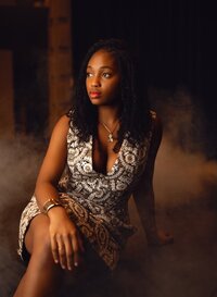 Senior portrait at the theater in Mobile, Alabama -- wearing an elegant dress with fog in the background.
