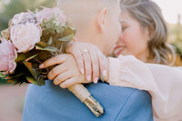 engaged couple almost kissing in the sunset light engagement sesion pictures showing the engagemnt ring