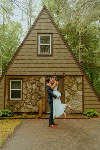couple kissing outside cabin
