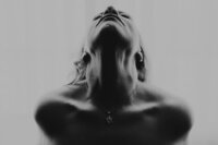 black and white image of womans collar bone and neck 