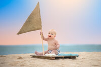 Baby sitting outdoors near the water in soft natural light in Eastern North Carolina