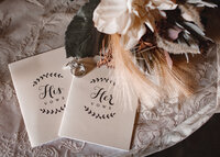 Flat lay with his and her vow books for a luxury wedding.