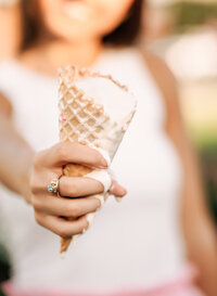 Senior portrait in Gulf Shores, Alabama — close-up of her class ring and a melting ice cream
cone outside TCBY.