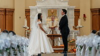 bride and groom getting blessed by priest before exchanging vows