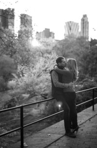 Central park engagement photos, Deborah Zoe Photography. A couple kiss with Central Park in the background.