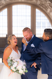 san francisco city hall groomsmen and emotional groom