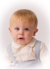 Baby peers into the camera during Heirloom Portrait Session in Charleston.