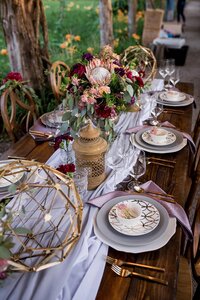 Boho wedding table setting with floral centerpiece