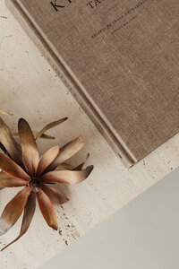 kaboompics_The book lies on a travertine table - Kinfolk - dried flower