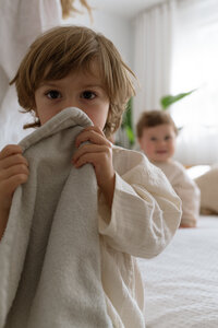 Petit garçon qui regarde la caméra avec sa doudou.