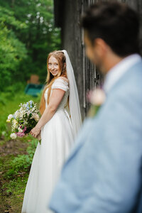 over the shoulder shot of bride admiring her husband