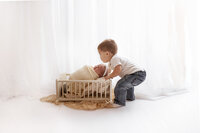 Big brother meets his baby sister during their newborn session with Jennifer Brandes Photography, serving Jordan and South Central Minnesota.