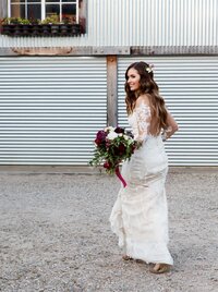 Bride standing outdoors with bouquet after ceremony