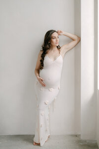 Expecting mother in white dress in Mintroom studio, Miami maternity photographer