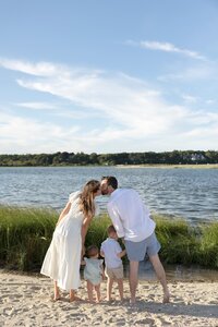 A coastal New England family session with toes in the sand and salty snuggles by the water's edge. North Shore Family Photographer. Deborah Zoe Photography.