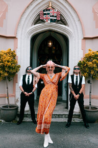 iconic guests captured in doorway at tawstock court having fun captured by colourful documentary wedding photographer