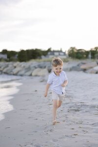 A coastal New England family session with toes in the sand and salty snuggles by the water's edge. North Shore Family Photographer. Deborah Zoe Photography.