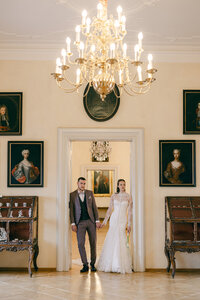 Elegant destination wedding couple posing in the grand halls of Lobkowicz Palace, Prague, in a fine art storytelling style.
