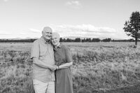 Grandparents hugging each other during outdoor family session in Bend, Oregon.