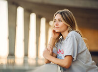 Senior portrait at Gulf State Park in Gulf Shores, Alabama — leaning on a wooden railing and
looking toward the sunset.