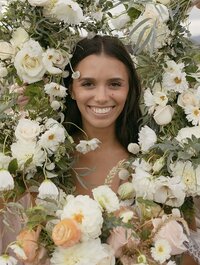 Smiling bride with florals by Flowergirl Cville and photography by Brittany Stark Studios.