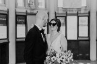 Black and white image of bride and groom looking at each other