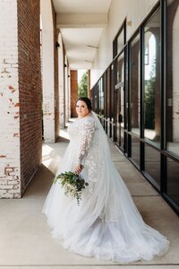 Bride portrait in the covered walkway at The Refinery, a modern wedding venue near Louisville