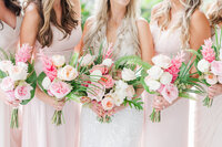 bridesmaids holding pink flower bouquets