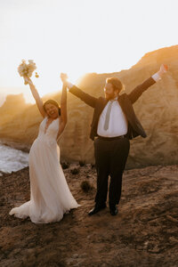 bride and groom kissing on mountain