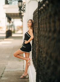 Senior portrait in downtown Foley, Alabama — leaning against a wrought-iron fence with a black
lantern above.