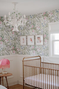 Framed newborn portraits in Chicago nursery with floral wallpaper