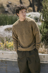 Olive sweater with a patterned yoke worn with cargo trousers, apparel campaign frame