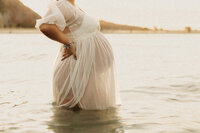Pregnant woman in the water during a maternity session in Christchurch