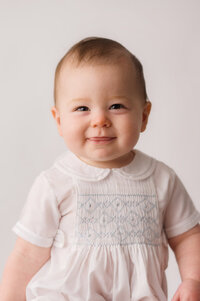 Heirloom Photographer in Charleston - Baby looks at the camera during Heirloom Photoshoot at Holy City Babies Portrait Studio in Charleston, SC.