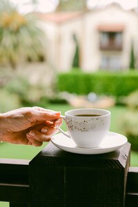 Coffee service handed across a ledge overlooking the hacienda courtyard