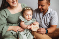 Charleston Baby Milestone Photographer - Baby sits with her parents during her Milestone Portrait Session at Holy City Babies Portrait Studio in Charleston, SC.