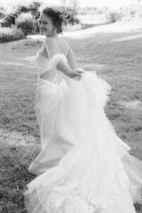 A stunning cinematic shot of a bride running in her wedding gown, focusing on the motion and high-fashion editorial vibe.