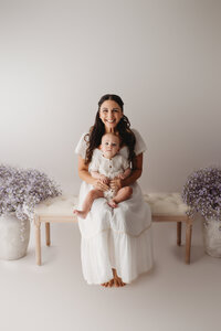 Charleston Motherhood Photographer - Mother poses with her baby during studio Mother's Day Mini Sessions at Holy City Babies Portrait Studio in Charleston, SC.