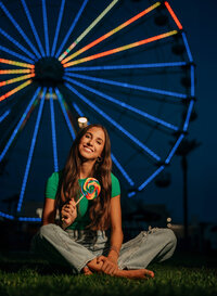 Senior portrait at The Wharf in Orange Beach, Alabama — holding a lollipop