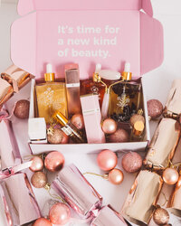 Styled product photography of beauty products arranged in a gift box with festive styling for campaign and paid advertising use