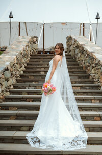 Bride on outdoor staircase at Eastwood Farm and Winery. Wedding florals by Flowergirl Cville and Photography by Jessa Rose Moments.