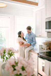 New mom holding newborn baby and looking up at her husband with love during Miami newborn session