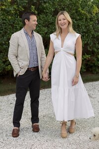 Man in tan jacket and women in white dress hold hands. Nantucket Wedding Photos.