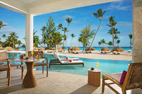 Spacious oceanfront suite with a private pool and tropical palm views, offering an exclusive luxury resort experience.