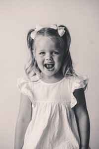 Little girl smiles at the camera during Personality Portrait Session in Charleston, SC.