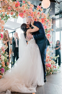 Groom embraces his wife while wearing a Kippah